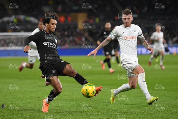 291025 - Swansea City v Manchester City - Carabao Cup Round 4 - Oscar Bobb of Manchester City is challenged by Josh Tymon of Swansea City