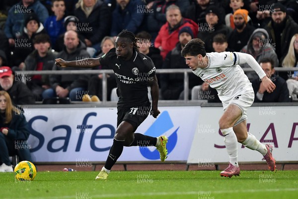 291025 - Swansea City v Manchester City - Carabao Cup Round 4 - Jeremy Doku of Manchester City is challenged by Josh Key of Swansea City