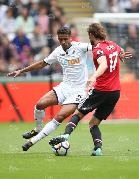 190817 - Swansea City v Manchester United, Premier League - Kyle Naughton of Swansea City closes down Daley Blind of Manchester United