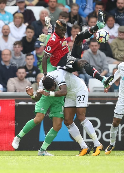 190817 - Swansea City v Manchester United, Premier League - Paul Pogba of Manchester United gets on top of Kyle Bartley of Swansea City as he looks to win the ball