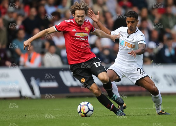 190817 - Swansea City v Manchester United, Premier League - Kyle Naughton of Swansea City challenges Daley Blind of Manchester United for the ball