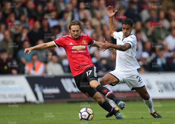 190817 - Swansea City v Manchester United, Premier League - Kyle Naughton of Swansea City challenges Daley Blind of Manchester United for the ball