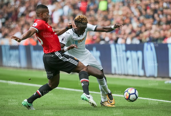 190817 - Swansea City v Manchester United, Premier League - Tammy Abraham of Swansea City is challenged by Antonio Valencia of Manchester United
