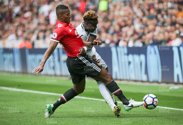 190817 - Swansea City v Manchester United, Premier League - Tammy Abraham of Swansea City is challenged by Antonio Valencia of Manchester United
