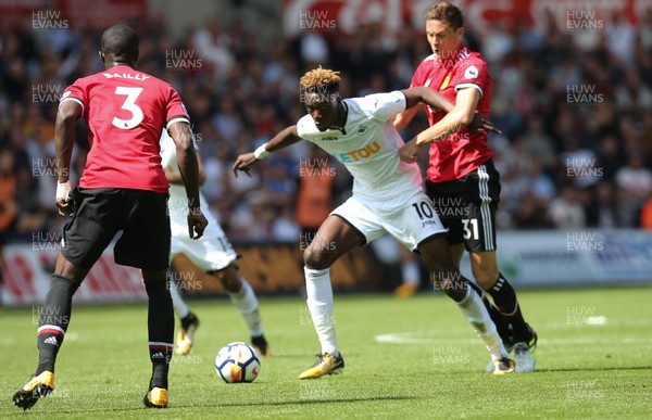 190817 - Swansea City v Manchester United, Premier League - Tammy Abraham of Swansea City is held by Nemanja Matic of Manchester United