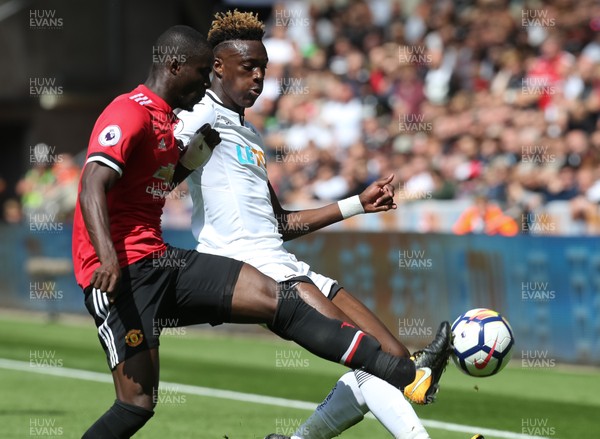 190817 - Swansea City v Manchester United, Premier League - Tammy Abraham of Swansea City and Eric Bailly of Manchester United compete for the ball