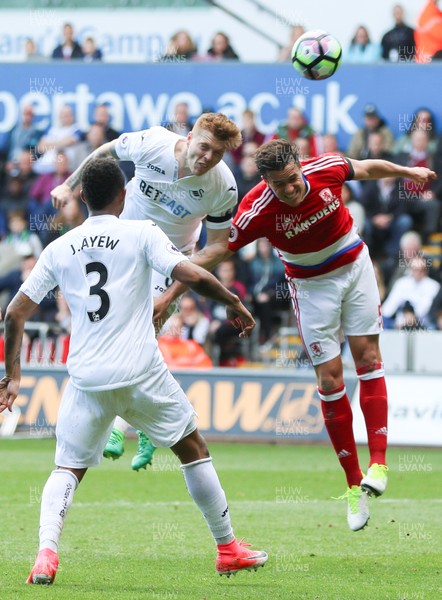 020417 - Swansea City v Middlesbrough, Premier League - Alfie Mawson of Swansea City heads at goal as Bernardo Espinosa of Middlesbrough challenges