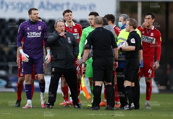 060321 - Swansea City v Middlesbrough - SkyBet Championship - Security staff stand between Middlesbrough Manager Neil Warnock and referee Gavin Ward at full time