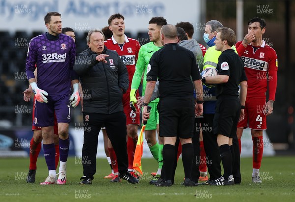060321 - Swansea City v Middlesbrough - SkyBet Championship - Security staff stand between Middlesbrough Manager Neil Warnock and referee Gavin Ward at full time