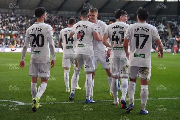 060426 - Swansea City v Middlesbrough - Sky Bet Championship - Zan Vipotnik of Swansea City celebrates scoring his second goal from the penalty spot with team mates