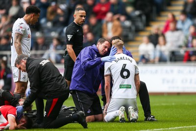 080325 - Swansea City v Middlesbrough - Sky Bet Championship - Harry Darling of Swansea City receives treatment for an injury