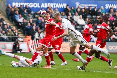 080325 - Swansea City v Middlesbrough - Sky Bet Championship - Harry Darling of Swansea City heads the ball towards goal