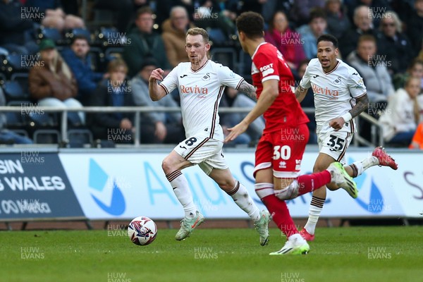 080325 - Swansea City v Middlesbrough - Sky Bet Championship - Lewis O'Brien of Swansea City takes on Neto Borges of Middlesborough