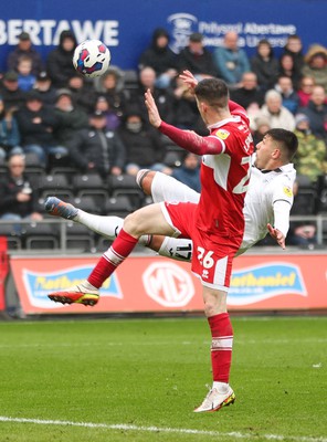 110323 - Swansea City v Middlesbrough, EFL Sky Bet Championship - Joel Piroe of Swansea City tries a spectacular shot at goal as Darragh Lenihan of Middlesbrough challenges