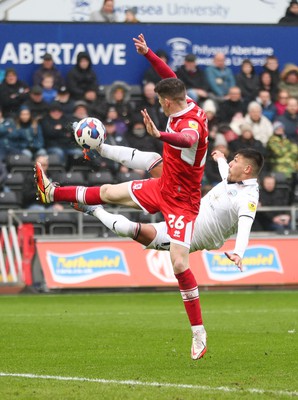 110323 - Swansea City v Middlesbrough, EFL Sky Bet Championship - Joel Piroe of Swansea City tries a spectacular shot at goal as Darragh Lenihan of Middlesbrough challenges