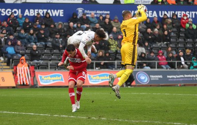 110323 - Swansea City v Middlesbrough, EFL Sky Bet Championship - Matty Sorinola of Swansea City takes a tumble as he goes over the top of Ryan Giles of Middlesbrough while looking to win the ball