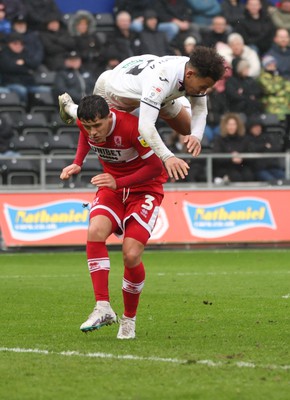 110323 - Swansea City v Middlesbrough, EFL Sky Bet Championship - Matty Sorinola of Swansea City takes a tumble as he goes over the top of Ryan Giles of Middlesbrough while looking to win the ball