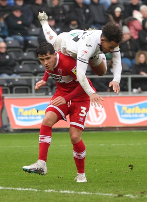 110323 - Swansea City v Middlesbrough, EFL Sky Bet Championship - Matty Sorinola of Swansea City takes a tumble as he goes over the top of Ryan Giles of Middlesbrough while looking to win the ball