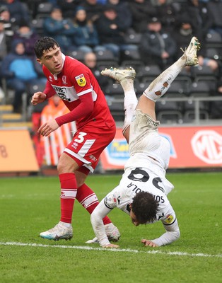 110323 - Swansea City v Middlesbrough, EFL Sky Bet Championship - Matty Sorinola of Swansea City takes a tumble as he goes over the top of Ryan Giles of Middlesbrough while looking to win the ball