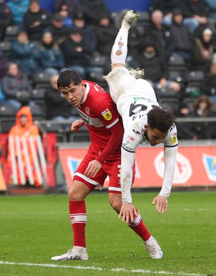 110323 - Swansea City v Middlesbrough, EFL Sky Bet Championship - Matty Sorinola of Swansea City takes a tumble as he goes over the top of Ryan Giles of Middlesbrough while looking to win the ball