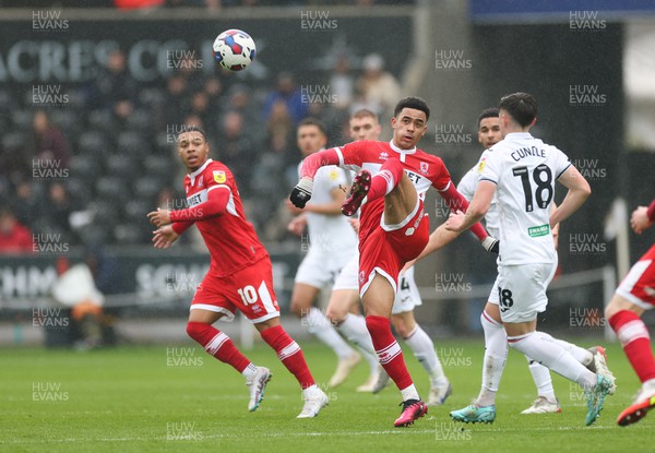 110323 - Swansea City v Middlesbrough, EFL Sky Bet Championship - Aaron Ramsey of Middlesbrough clears the ball as Luke Cundle of Swansea City closes in