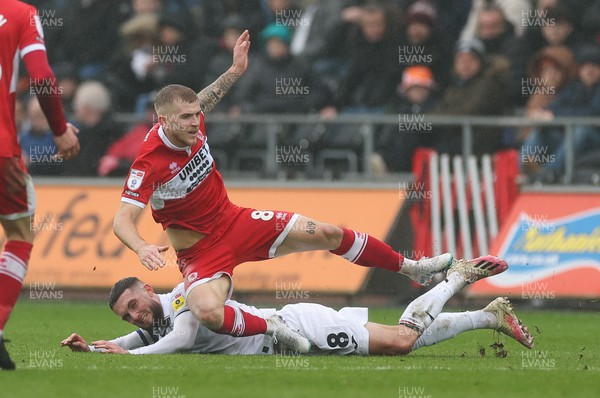 110323 - Swansea City v Middlesbrough, EFL Sky Bet Championship - Riley McGree of Middlesbrough is brought down by Matt Grimes of Swansea City