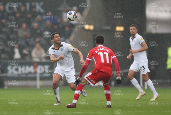 110323 - Swansea City v Middlesbrough, EFL Sky Bet Championship - Ben Cabango of Swansea City heads past Aaron Ramsey of Middlesbrough