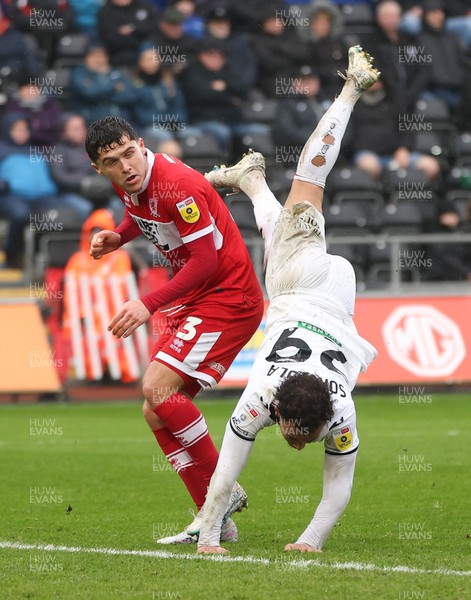 110323 - Swansea City v Middlesbrough, EFL Sky Bet Championship - Matty Sorinola of Swansea City takes a tumble as he goes over the top of Ryan Giles of Middlesbrough while looking to win the ball