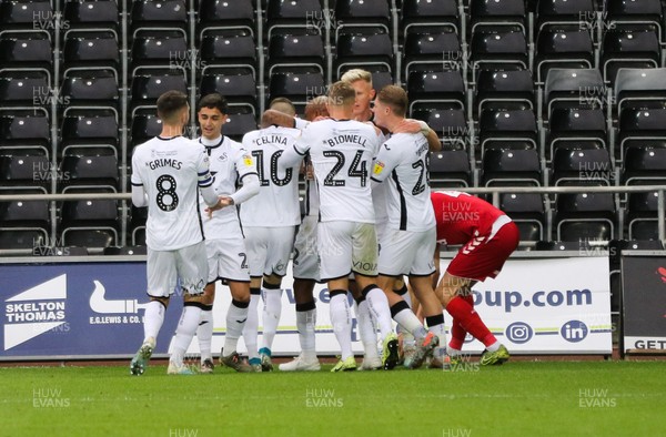 141219 - Swansea City v Middlesbrough, Sky Bet Championship - Team mates celebrate with Andre Ayew of Swansea City after he scores from the penalty spot