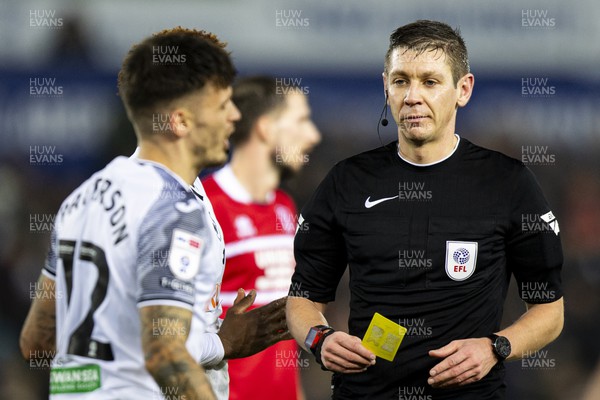 161223 - Swansea City v Middlesbrough - Sky Bet Championship - Match Referee James Bell shows Jamie Paterson of Swansea City a yellow card