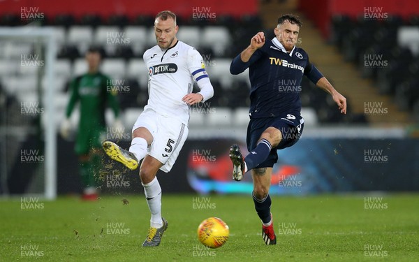 090219 - Swansea City v Millwall - SkyBet Championship - Mike van der Hoorn of Swansea City is challenged by Lee Gregory of Millwall