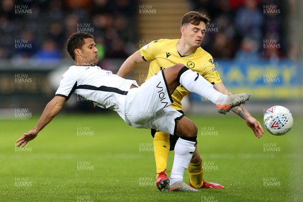 231119 - Swansea City v Millwall - SkyBet Championship - Wayne Routledge of Swansea City is tackled by Ben Thompson of Millwall