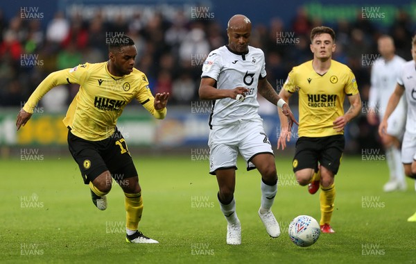 231119 - Swansea City v Millwall - SkyBet Championship - Andre Ayew of Swansea City is challenged by Mahlon Romeo of Millwall