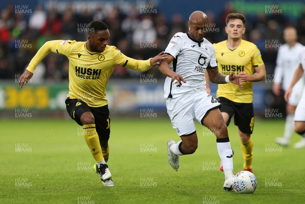 231119 - Swansea City v Millwall - SkyBet Championship - Andre Ayew of Swansea City is challenged by Mahlon Romeo of Millwall