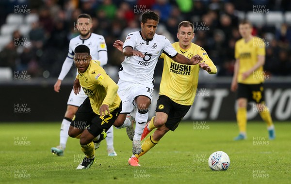 231119 - Swansea City v Millwall - SkyBet Championship - Wayne Routledge of Swansea City is challenged by Mahlon Romeo and Jed Wallace of Millwall