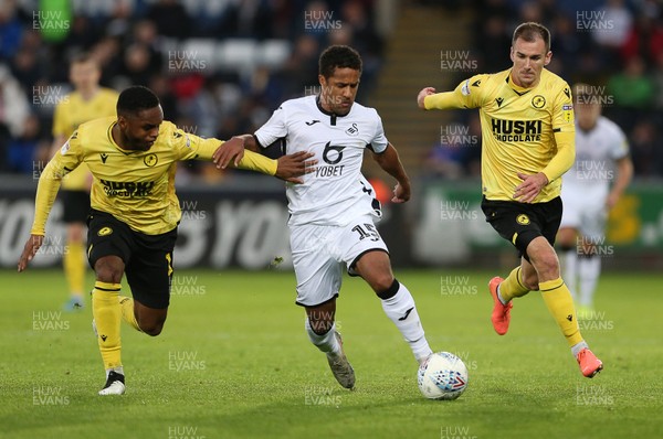 231119 - Swansea City v Millwall - SkyBet Championship - Wayne Routledge of Swansea City is challenged by Mahlon Romeo and Jed Wallace of Millwall