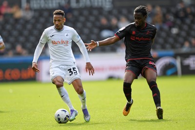 270925 - Swansea City v Millwall - Sky Bet Championship - Ronald of Swansea City is challenged by Derek Mazou-Sacko of Millwall