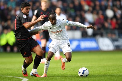 270925 - Swansea City v Millwall - Sky Bet Championship - Malick Yalcouye of Swansea City is challenged by Massimo Luongo of Millwall