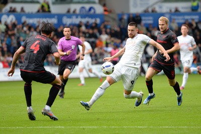 270925 - Swansea City v Millwall - Sky Bet Championship - Zan Vipotnik of Swansea City is challenged by Tristan Crama of Millwall