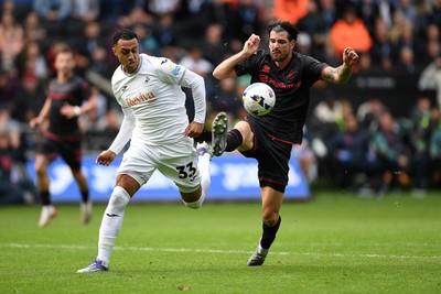 270925 - Swansea City v Millwall - Sky Bet Championship - Adam Idah of Swansea City is challenged by Tristan Crama of Millwall