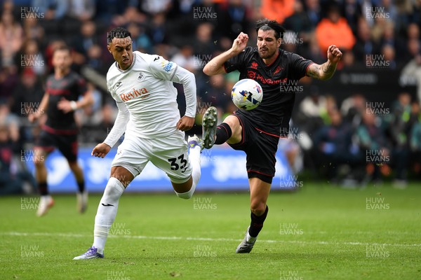 270925 - Swansea City v Millwall - Sky Bet Championship - Adam Idah of Swansea City is challenged by Tristan Crama of Millwall