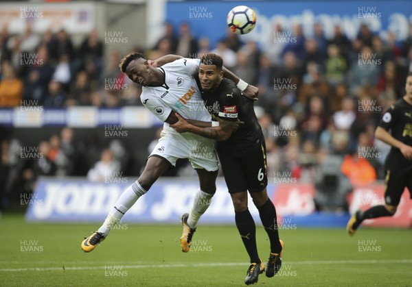 100917 - Swansea City v Newcastle United, Premier League -  Tammy Abraham of Swansea City tries to get a headed attempt at goal as Jamaal Lascelles of Newcastle United challenges