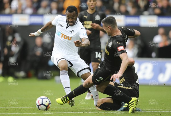 100917 - Swansea City v Newcastle United, Premier League - Jordan Ayew of Swansea City takes on Ciaran Clark of Newcastle United