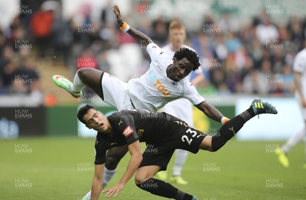 100917 - Swansea City v Newcastle United, Premier League - Wilfried Bony of Swansea City and Mikel Merino of Newcastle United tangle as they compete for the ball