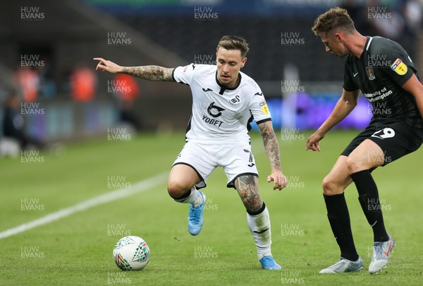 130819 - Swansea City v Northampton Town, Carabao Cup Round One - Barrie McKay of Swansea City takes on Joe Bunney of Northampton Town