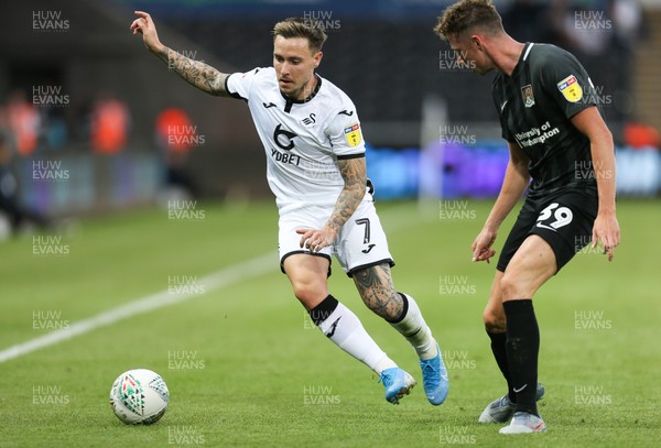 130819 - Swansea City v Northampton Town, Carabao Cup Round One - Barrie McKay of Swansea City takes on Joe Bunney of Northampton Town