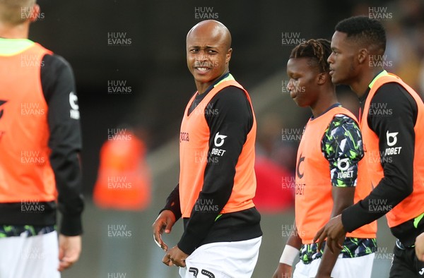 130819 - Swansea City v Northampton Town, Carabao Cup Round One - Andre Ayew of Swansea City warms up at half time