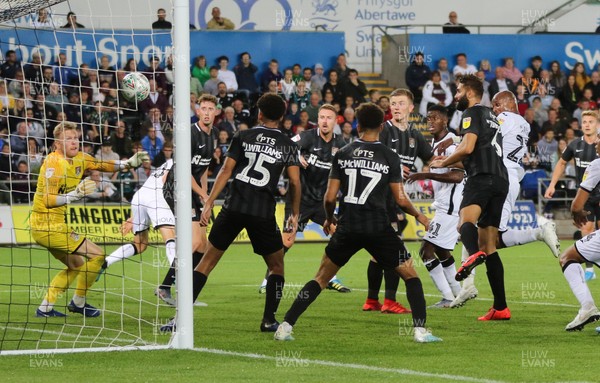 130819 - Swansea City v Northampton Town, Carabao Cup Round One - Andre Ayew of Swansea City, right, heads to score his second goal and Swansea's third