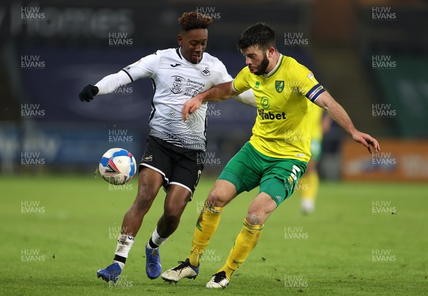 050221 - Swansea City v Norwich City - SkyBet Championship - Jamal Lowe of Swansea City is tackled by Grant Hanley of Norwich City
