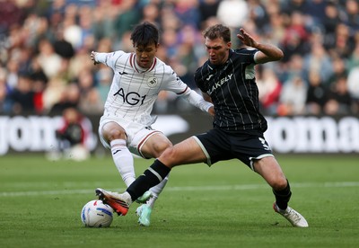 101026 - Swansea City v Norwich City - SkyBet Championship - Eom Ji-Sung of Swansea is tackled by Jack Stacey of Norwich 